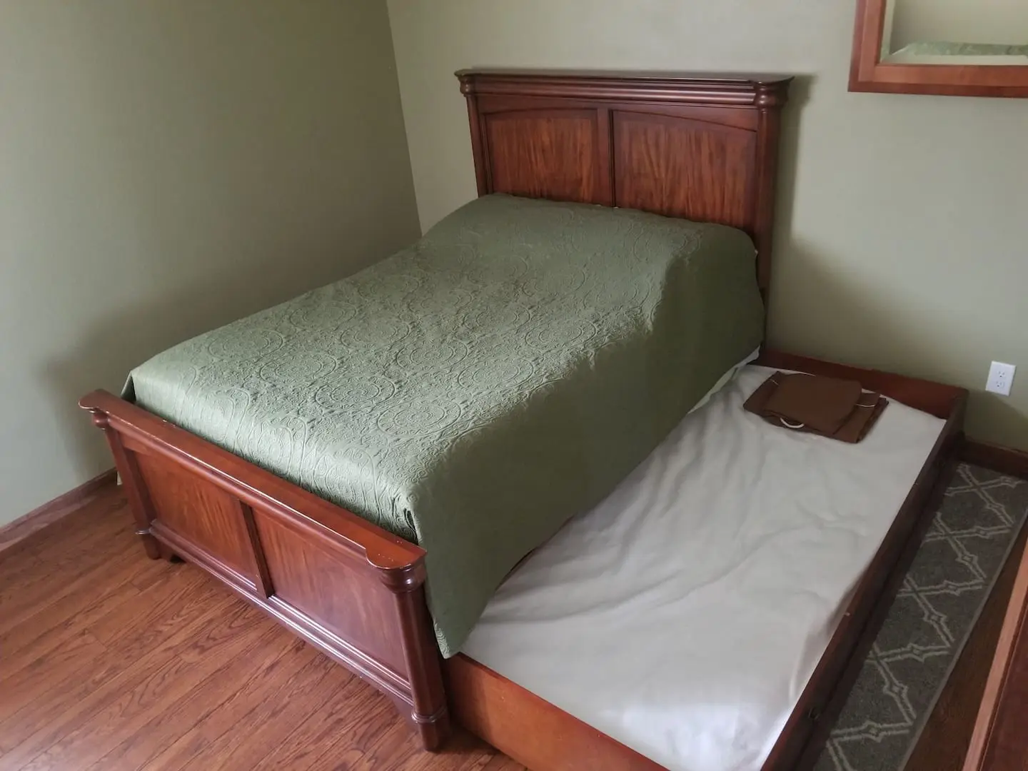 Second bedroom with a full bed, pull-out twin trundle and sage-green bedding