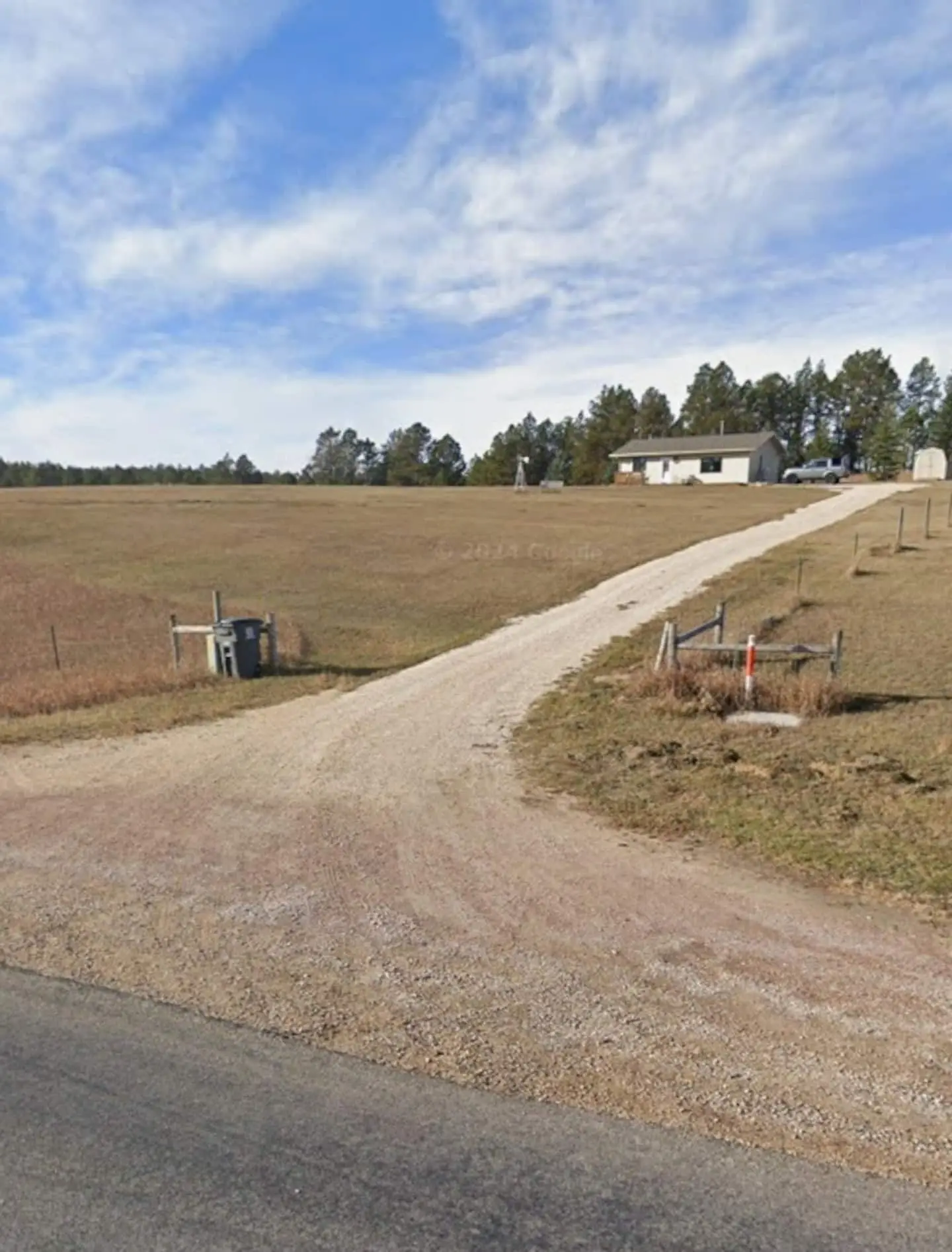The gravel drive leading from the road across the meadow toward the cabin